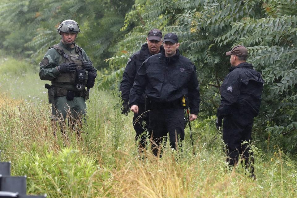 Police work on in the area of an hours long standoff with a group of armed men that partially shut down interstate 95, Saturday, July 3, 2021, in Wakefield, Mass. Massachusetts state police say nine suspects have been taken into custody. (AP Photo/Michael Dwyer)