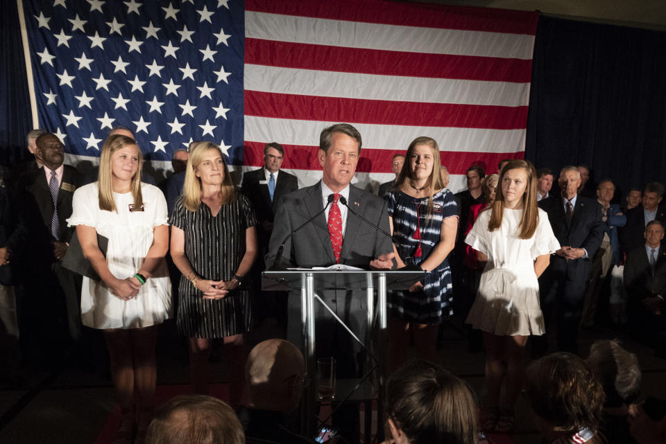 Georgia Secretary of State Brian Kemp, backed by family, speaks during a unity rally, Thursday, July 26, 2018, in Peachtree Corners, Ga. Kemp and fellow Republican Casey Cagle, who was on hand, faced off in a heated gubernatorial primary runoff race which Kemp won. (AP Photo/John Amis)