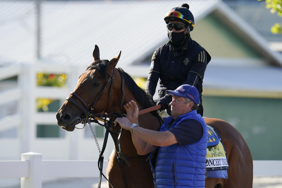 Preakness hopeful Concert Tour is walked to the track for a morning exercise at Pimlico Race Course ahead of the Preakness Stakes horse race, Tuesday, May 11, 2021, in Baltimore. (AP Photo/Julio Cortez)