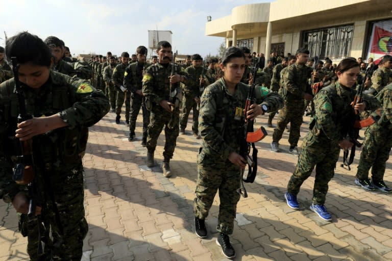 Syrian fighters from the Kurdish Women's Protection Units (YPJ) and People's Protection Units (YPG) attend the March 3, 2018 funeral in Qamishli of members killed fighting the Islamic State group in Deir Ezzor