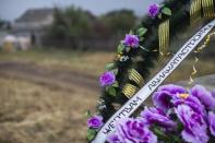 A wreath with an inscription reading "To the victims of the air crash" is pictured at the site where the downed Malaysia Airlines flight MH17 crashed, near the village of Hrabove (Grabovo) in Donetsk region, eastern Ukraine September 9, 2014. REUTERS/Marko Djurica