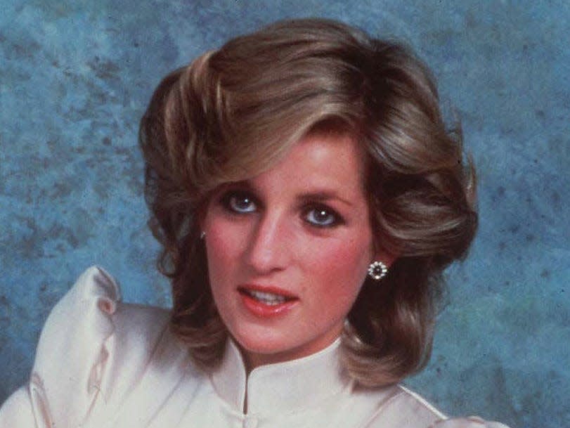 Princess Diana wearing sapphire and diamond stud earrings.