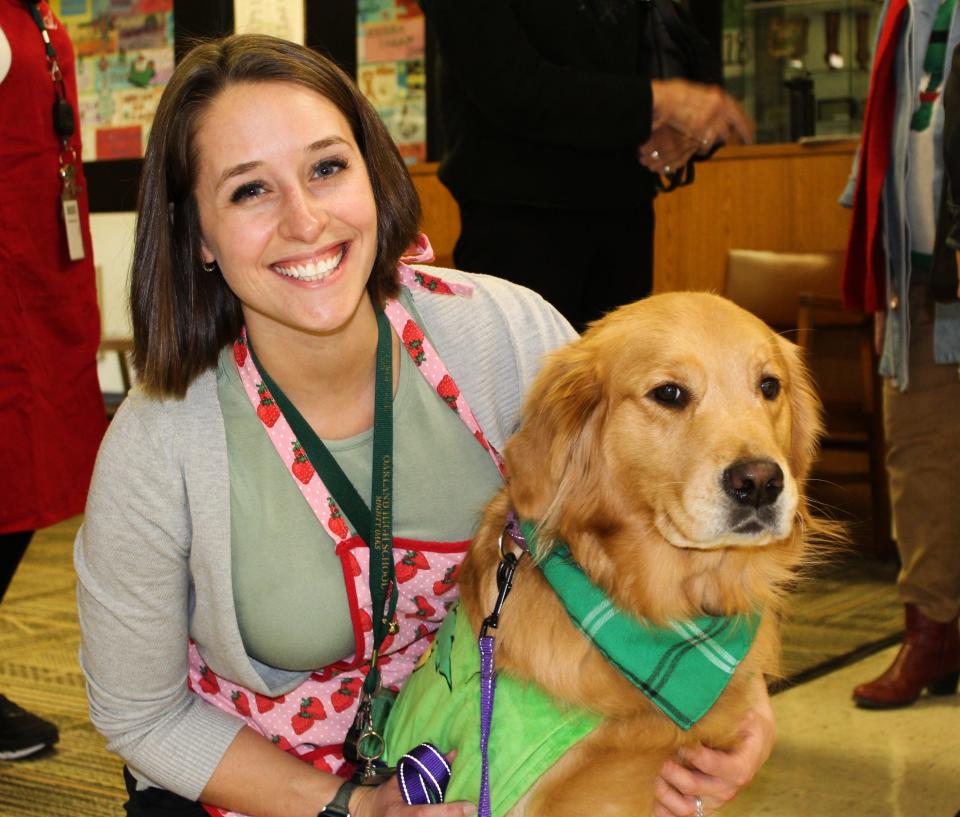 Oakland Academy Principal Kathryn Parthun poses with Fawn, an emotional support dog at the school. Fawn spends her days in the English classroom and the "Amygdala reset room," Parthun said.