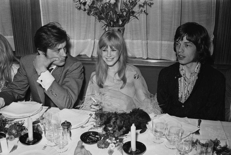 <p>French actor Alain Delon, English singer and actress Marianne Faithfull, and English singer Mick Jagger at a meeting with film director Jack Cardiff to discuss his film 'The Girl on a Motorcycle', 1967. (Photo by Express/Hulton Archive/Getty Images)</p>
