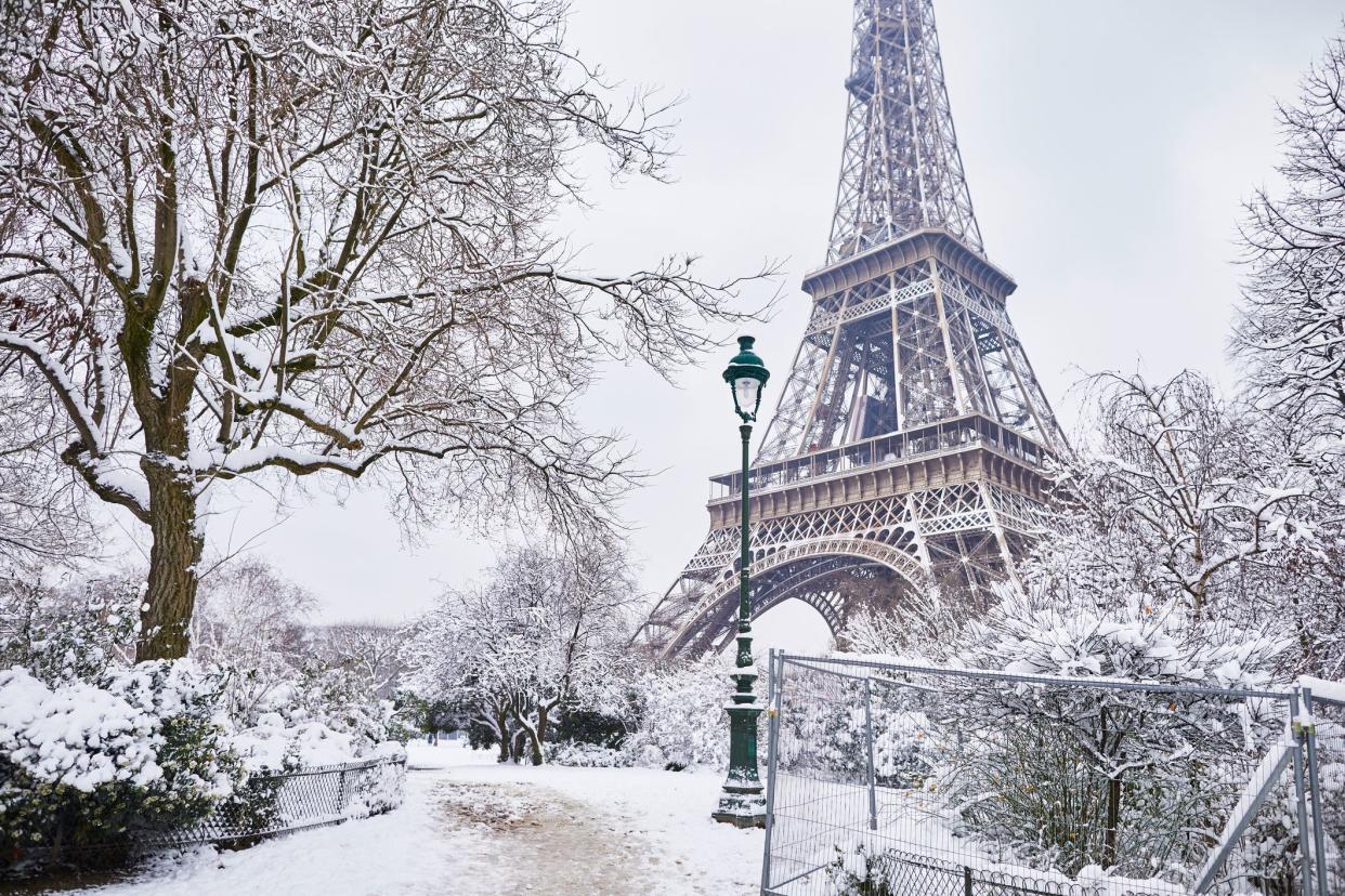 Scenic view to the Eiffel tower on a day with heavy snow. Unusual weather conditions in Paris