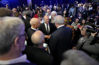 German chancellor Olaf Scholz, center, is surrounded by people at the World Economic Forum in Davos, Switzerland, Thursday, May 26, 2022. The annual meeting of the World Economic Forum is taking place in Davos from May 22 until May 26, 2022. (AP Photo/Markus Schreiber)