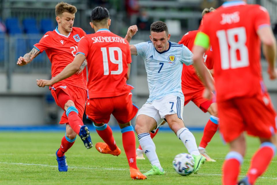 John McGinn is surrounded by Luxembourg players - GETTY IMAGES