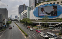 An educational visual on the prevention of the new coronavirus prevention is shown on a giant screen in a nearly-deserted intersection in Bangkok, Thailand, Thursday, April 2, 2020. A state of emergency has been declared in the country to allow the government to impose stricter measures to control the coronavirus that has infected hundreds of people in the region. The new coronavirus causes mild or moderate symptoms for most people, but for some, especially older adults and people with existing health problems, it can cause more severe illness or death. (AP Photo/Gemunu Amarasinghe)