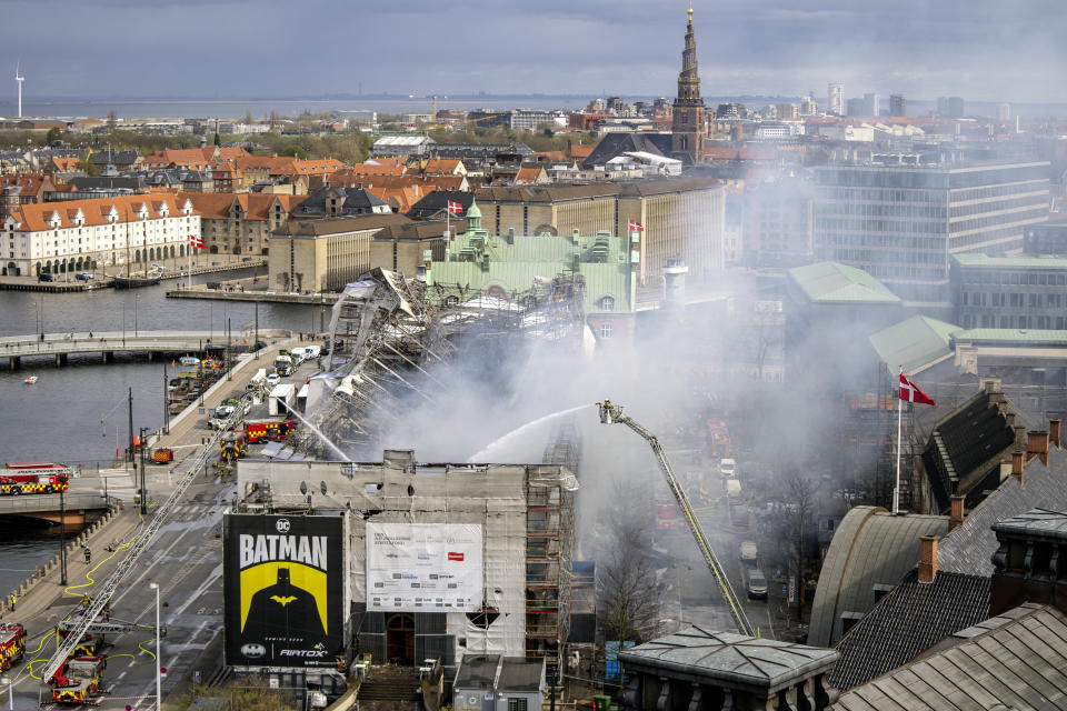 Firefighters work on the building after a fire broke out at the Stock Exchange in Copenhagen, Tuesday, April 16, 2024. The fire was reported Tuesday morning in the historic building, which was undergoing renovation. (Ida Marie Odgaard/Ritzau Scanpix)