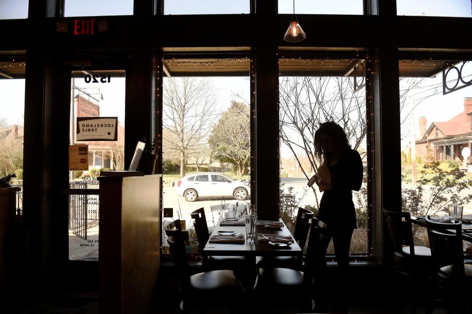 Singer-songwriter Jamie Floyd preps her tables at Lockland Table on March 15.