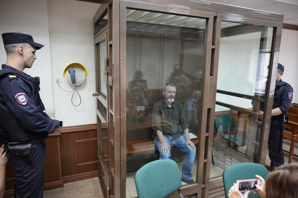 Igor Girkin also know as Igor Strelkov, the former military chief for Russia-backed separatists in eastern Ukraine, sits in a glass cage in a courtroom at the Moscow's City Court in Moscow, Russia, on Tuesday, Aug. 29, 2023. A prominent Russian hard-line nationalist who accused President Vladimir Putin of weakness and indecision in Ukraine was detained on charges of extremism. (AP Photo/Alexander Zemlianichenko)