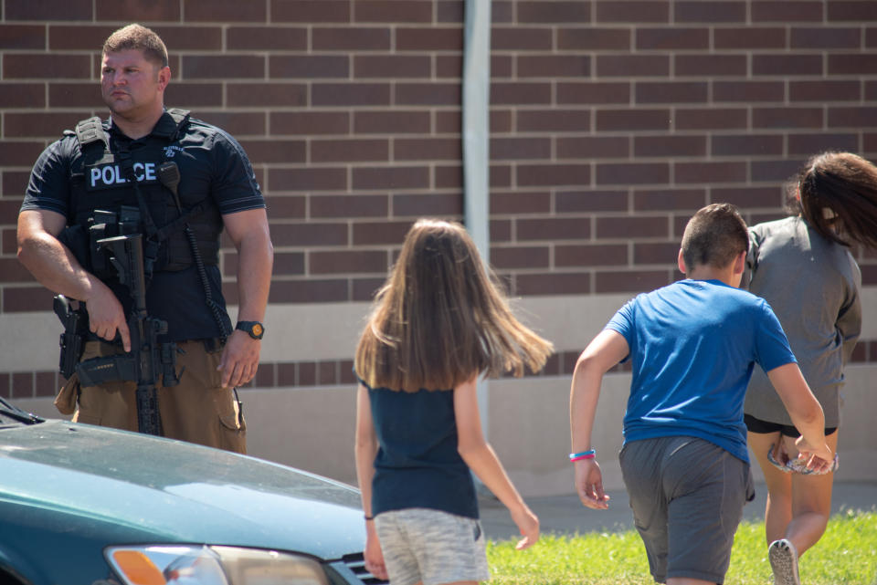 Police assess the scene outside Noblesville High.