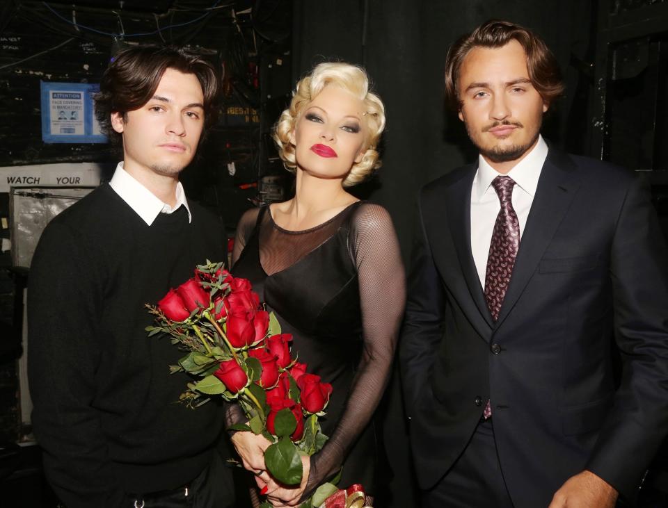 NEW YORK, NEW YORK - APRIL 12: (EXCLUSIVE OPENING) (LR) Dylan Jagger Lee, Pamela Anderson and Brandon Thomas Lee pose backstage during the opening night of her Broadway debut as Roxie Hart in the musical 