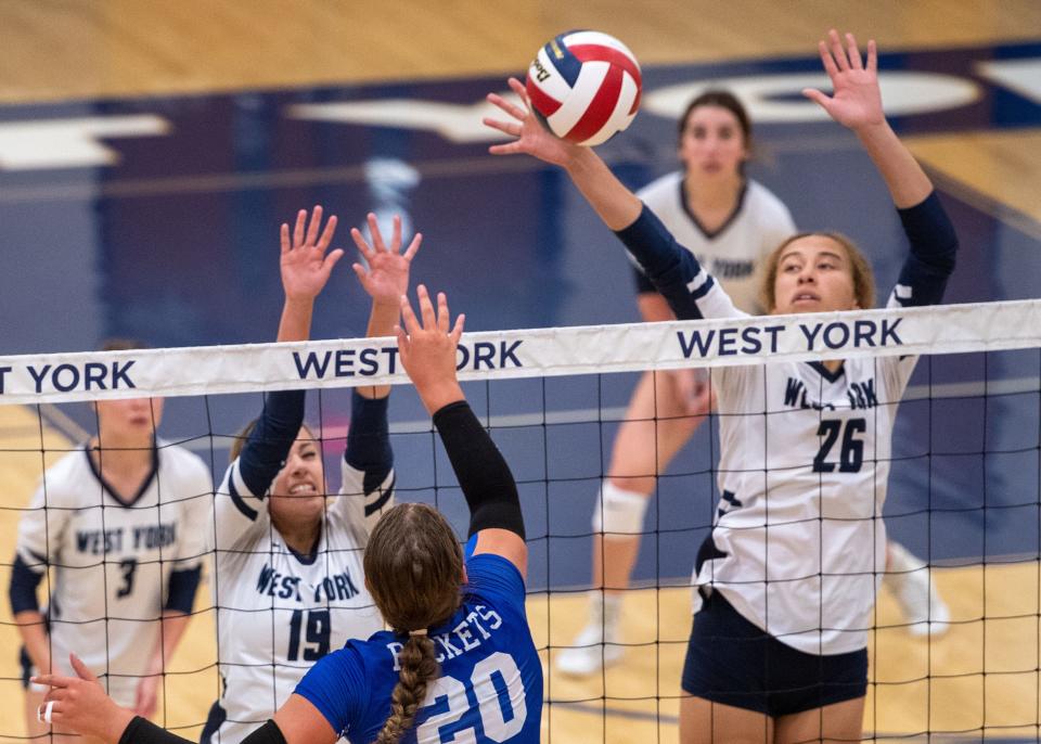 West York’s Faith Walker (26) gets a hand on a hit by Spring Grove’s Mackenzie Boyer (20) in their match on Tuesday, Aug. 29, 2023.