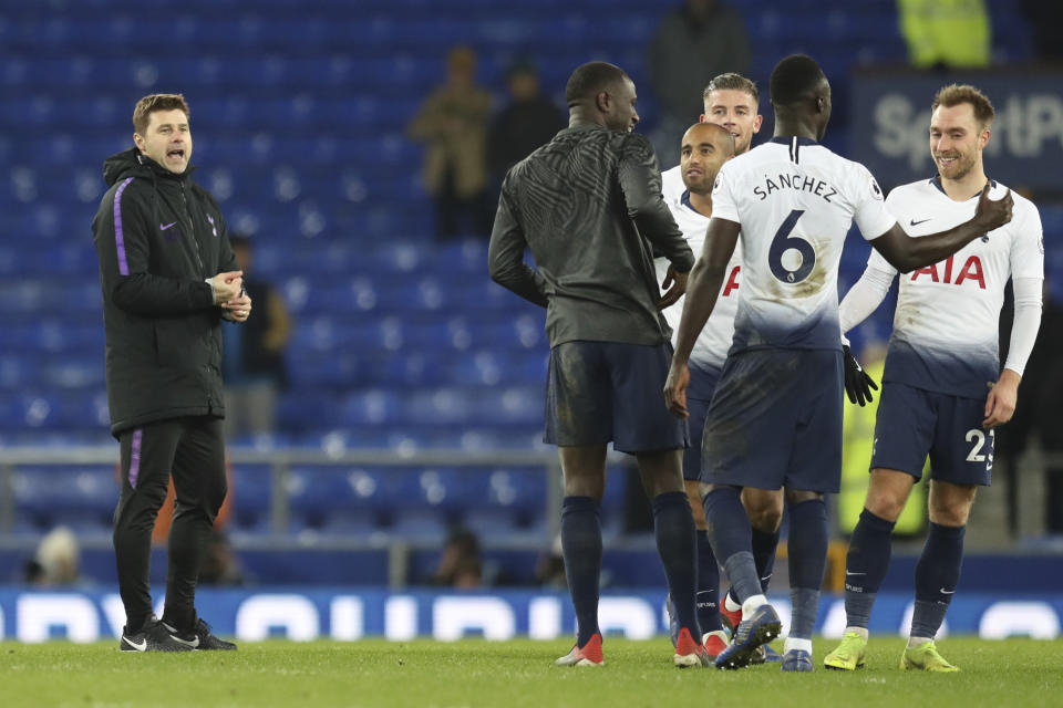 Tottenham coach Mauricio Pochettino, left celebrates with his players at the end of the English Premier League soccer match between Everton and Tottenham at Goodison Park Stadium, in Liverpool, England, Sunday, Dec. 23, 2018. (AP Photo/Jon Super)