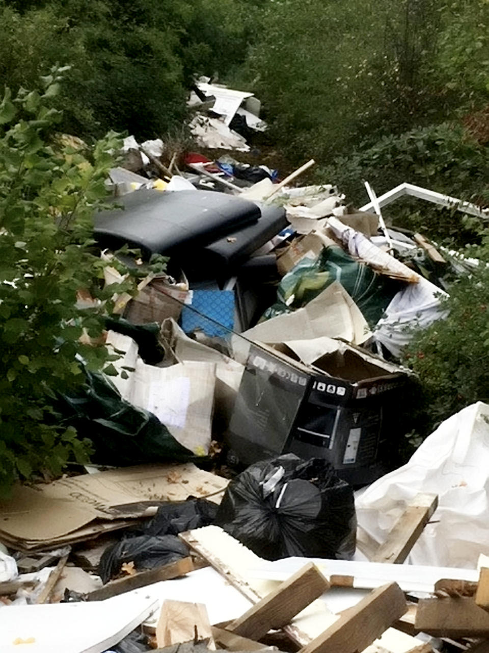 Shocking pictures show the devastation caused by fly-tippers who dumped a whopping 45 TONNES of rubbish near a main road. See SWNS story SWMDrubbish.  Council leaders have been forced to spend Â£20,000 of taxpayersâ cash removing two huge mountains of dumped waste.  The fly-tipped rubbish only came to the attention of the council after the piles of waste became so large motorists were able to see if from the road.  The two mountains of rubbish have been building up near the very busy section of the A6 near Market Harborough, Leics.  A combined effort from FCC Environment, Leicester County Council traffic management team and Harborough District Council managed to tackle the mess.   It took three days for the waste to be removed, which cost Â£20,000.  Dozens of workers and many heavy-duty vehicles were used to transport the rubbish away.