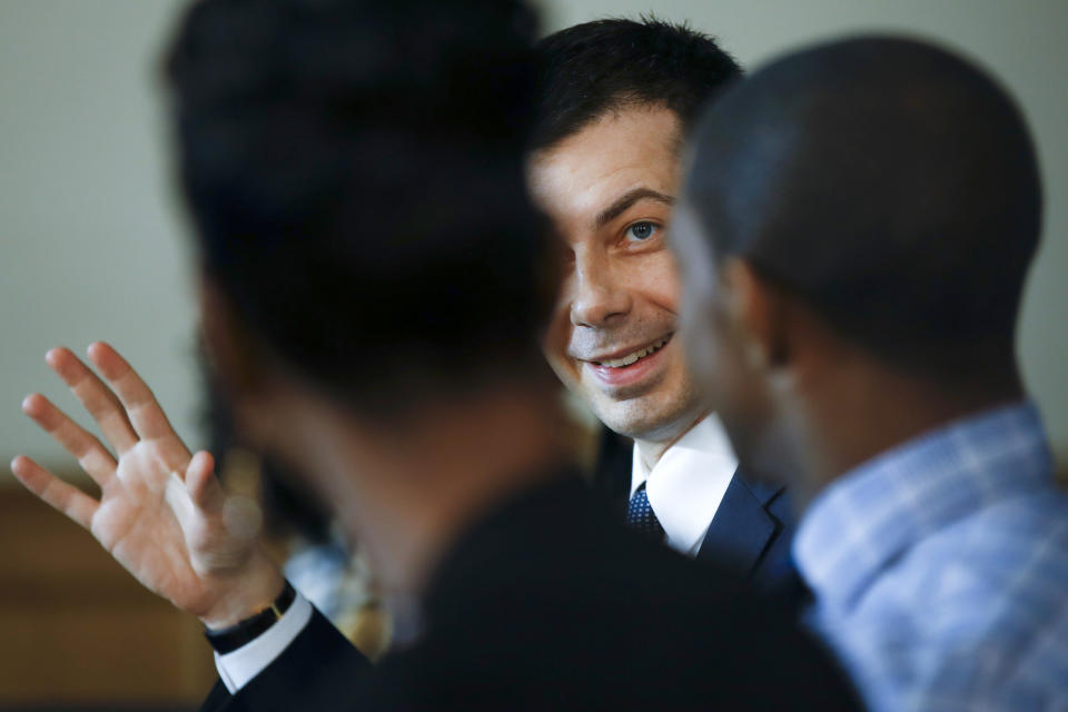 Democratic presidential candidate former South Bend, Ind., Mayor Pete Buttigieg, center, takes park in a roundtable discussing health equity with Stephania Priester, left, and Jalen Elrod, right, Thursday, Feb. 27, 2020, at the Nicholtown Missionary Baptist Church in Greenville, S.C. (AP Photo/Matt Rourke)