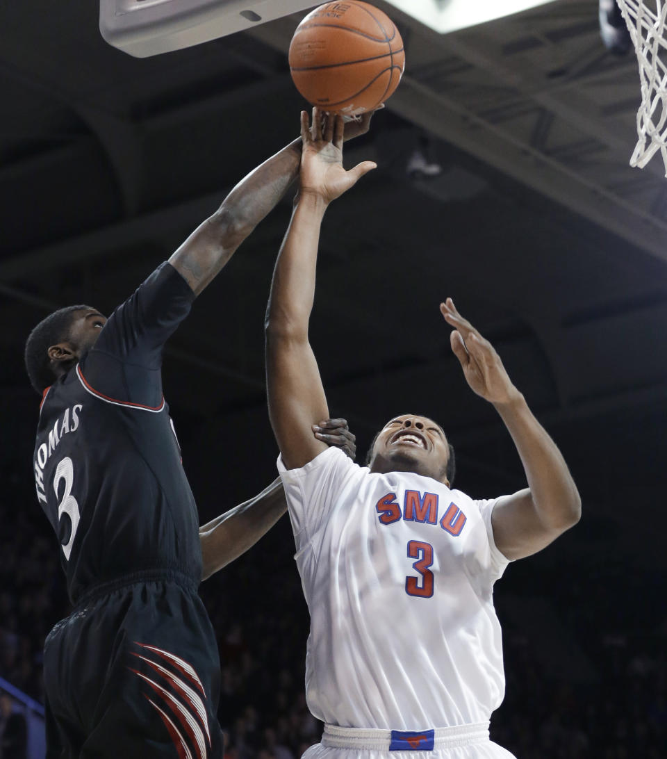 Cincinnati forward Shaquille Thomas, left, and SMU guard Sterling Brown jump for a rebound during the first half of an NCAA college basketball game Saturday, Feb. 8, 2014, in Dallas. (AP Photo/LM Otero)