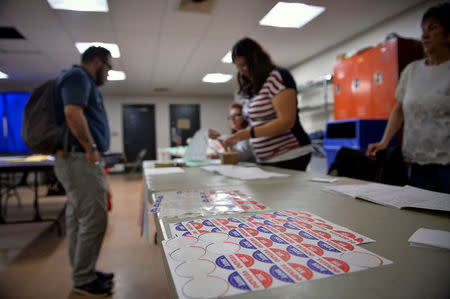 Voters sign in to cast their ballot in the Pennsylvania primary at a polling place in Philadelphia, Pennsylvania, U.S., April 26, 2016. REUTERS/Charles Mostoller