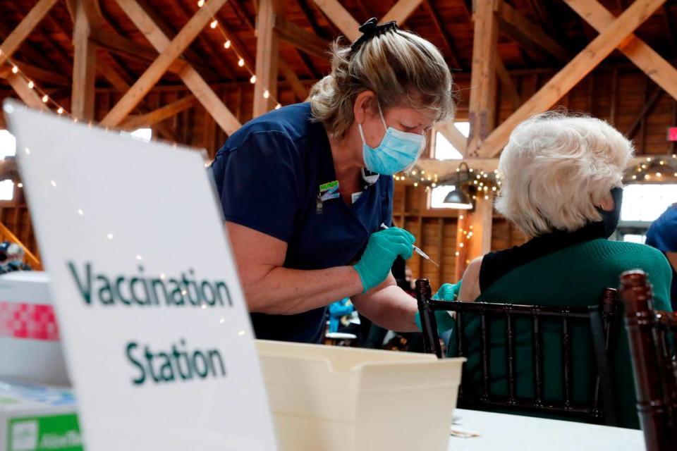 Wanda Steele, RN, prepares to give a vaccine shot during a COVID-19 vaccination clinic administered by FirstHealth of the Carolinas at the Fair Barn in Pinehurst, N.C., Tuesday, January 26, 2021.