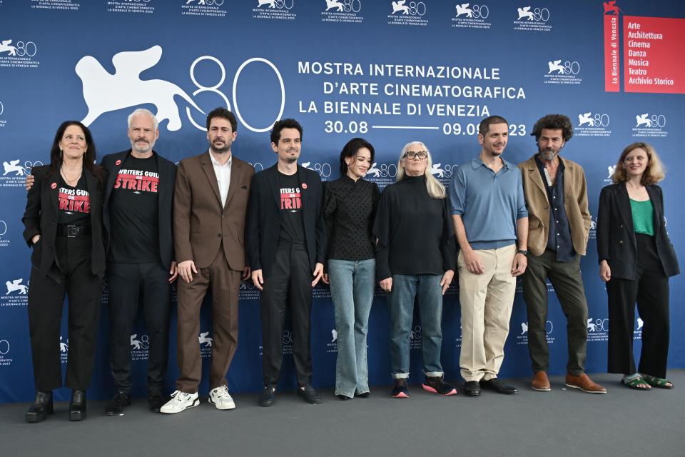 from left : US director and journalist Laura Poitras, Irish screenwriter and director Martin McDonagh, Palestinian actor Saleh Bakri, US director and president of the jury Damien Chazelle, Chinese actress Shu Qi, New Zealand director Jane Campion, Italian director Gabriele Mainetti, Argentinian screenwriter and director Santiago Mitre and French director Mia Hansen-Løve pose on August 30, 2023, during a photocall for the Jury of the 80th International Venice Film Festival at Venice Lido. (Photo by Tiziana FABI / AFP) (Photo by TIZIANA FABI/AFP via Getty Images)