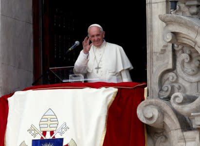 Pope Francis waves to the crowd from the balcony of the Archbishop's Palace of Lima, in Lima, Peru January 21, 2018. REUTERS/Henry Romero