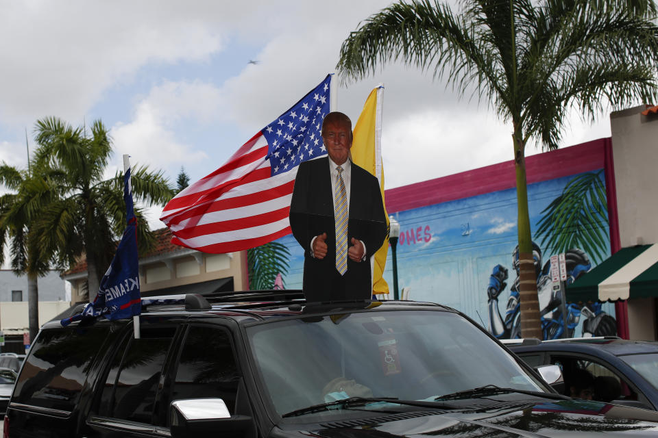 Supporters of President Donald Trump drive in caravan down Calle Ocho in the Little Havana neighborhood of Miami, Saturday, Oct. 31, 2020. (AP Photo/Rebecca Blackwell)