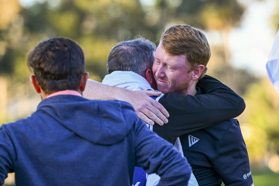 Hayden Springer hugs his caddie on the 18th green. (Tracy Wilcox/PGA Tour via Getty Images)