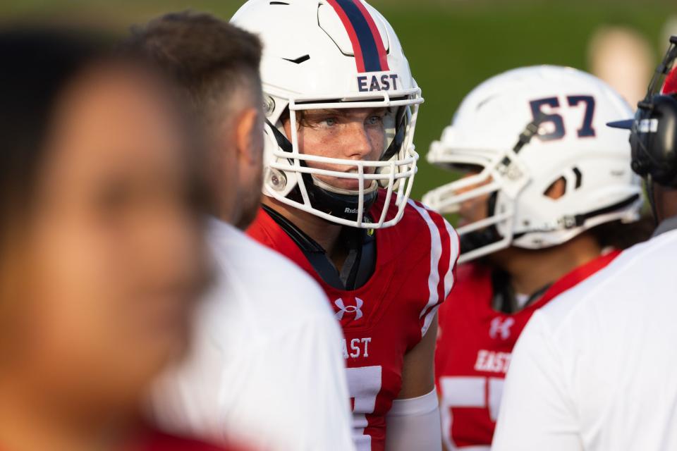 East’s Tucker McCormick listens to his coaches during the high school football season opener against Orem at East High School in Salt Lake City on Friday, Aug. 11, 2023. | Megan Nielsen, Deseret News