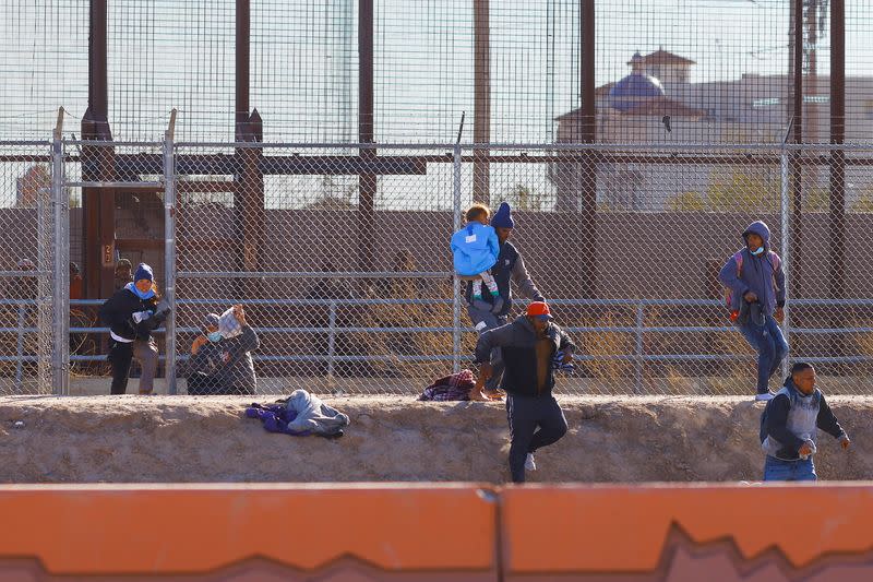 FILE PHOTO: Migrants crossing into the United States from Mexico, in El Paso