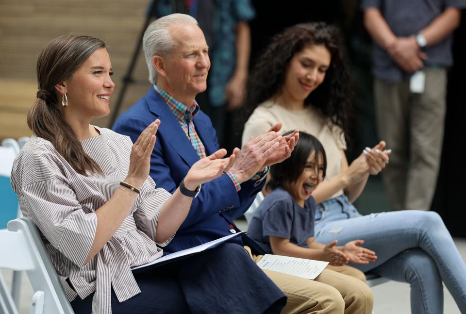 Salt Lake City Mayor Erin Mendenhall, state homeless coordinator Wayne Niederhauser and James Ramirez and his mother Stephanie Ramirez, who are residents of The Aster, applaud during remarks at a ribbon-cutting ceremony for The Aster, a three-building development that includes low-income housing, commercial and public spaces, in Salt Lake City on Tuesday, May 2, 2023. | Kristin Murphy, Deseret News