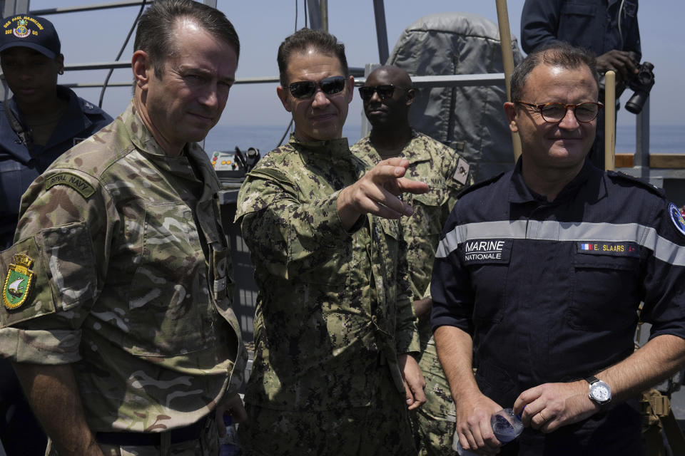 From left, Commodore Philip Dennis, commander of the United Kingdom Maritime Component Command, Vice Adm. Brad Cooper of the U.S. Navy's Mideast-based 5th Fleet and Vice Adm. Emmanuel Slaars, joint commander of the French forces deployed in the Indian Ocean, look out from the USS Paul Hamilton in the Strait of Hormuz Friday, May 19, 2023. The Mideast-based chiefs of the U.S., British and French navies transited the Strait of Hormuz on Friday aboard an American warship, a sign of their unified approach to keep the crucial waterway open after Iran seized two oil tankers. (AP Photo/Jon Gambrell)