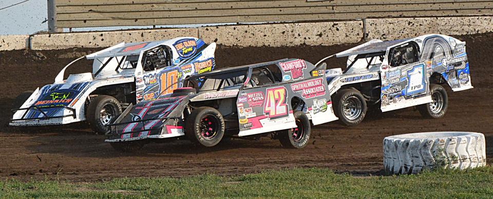 Nate Heinrich of Bellingham, Minn. (10H), and Chaun Peterson of Aberdeen (42) lead Tyler Peterson of Hickson , N.D. (1TPO) during a modified heat race at Casino Speedway on Sunday, July 16, 2023.