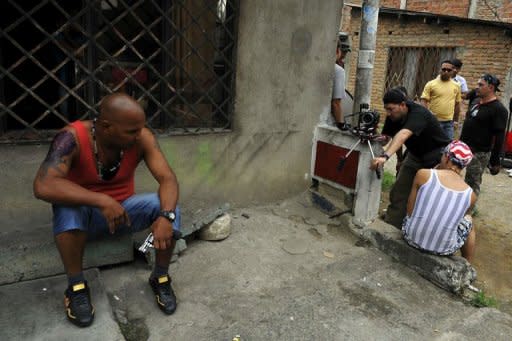 Non-professional actor Hector Gomez (L), 38, acts during the shooting of the movie "Petecuy" directed by Colombian Oscar Hincapie (out of picture) in Cali, department of Valle del Cauca, Colombia. In Petecuy, one of the roughest neighborhoods in Cali, one of Colombia's most dangerous cities, life and art are intertwined