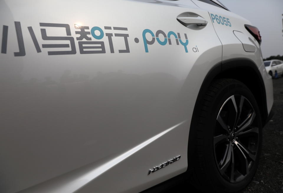 A logo of Pony.ai is seen on a Lexus vehicle equipped with the company's autonomous driving system, which will serve as a robotaxi, in Beijing, China May 13, 2021. REUTERS/Tingshu Wang - RC2WEN9E9CYF