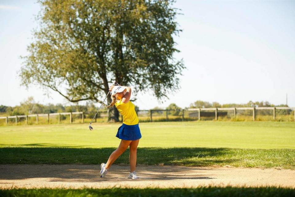 Henry Clay’s Kylah Lunsford takes a shot from a bunker during the Region 9 girls golf championship in Versailles on Sept. 20, 2022.