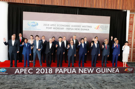 Leaders pose for a family photo ahead of the retreat session during the APEC Summit in Port Moresby, Papua New Guinea November 18, 2018. Front row (L to R): Australia's Prime Minister Scott Morrison, Brunei's Sultan Hassanal Bolkiah, Canada's Prime Minister Justin Trudeau, Chile's President Sebastian Pinera, China's President Xi Jinping, Papua New Guinea's Prime Minister Peter O'Neill, Japan's Prime Minister Shinzo Abe, U.S. Vice President Mike Pence, Malaysia's Prime Minister Mahathir Mohamad, Indonesia's President Joko Widodo, Hong Kong's Chief Executive Carrie Lam. Back Row (L to R): Mexico's Undersecretary for Foreign Trade Juan Carlos Baker Pineda, New Zealand's Prime Minister Jacinda Ardern, Peru's Foreign Minister Nestor Popolizio, Philippines President Rodrigo Duterte, Russia's Prime Minister Dmitry Medvedev, Singapore's Prime Minister Lee Hsien Loong, South Korea's President Moon Jae-in, Thailand's Prime Minister Prayuth Chan-o-cha,Vietnam's Prime Minister Nguyen Xuan Phuc, Taiwanese delegate to APEC Morris Chang. REUTERS/David Gray