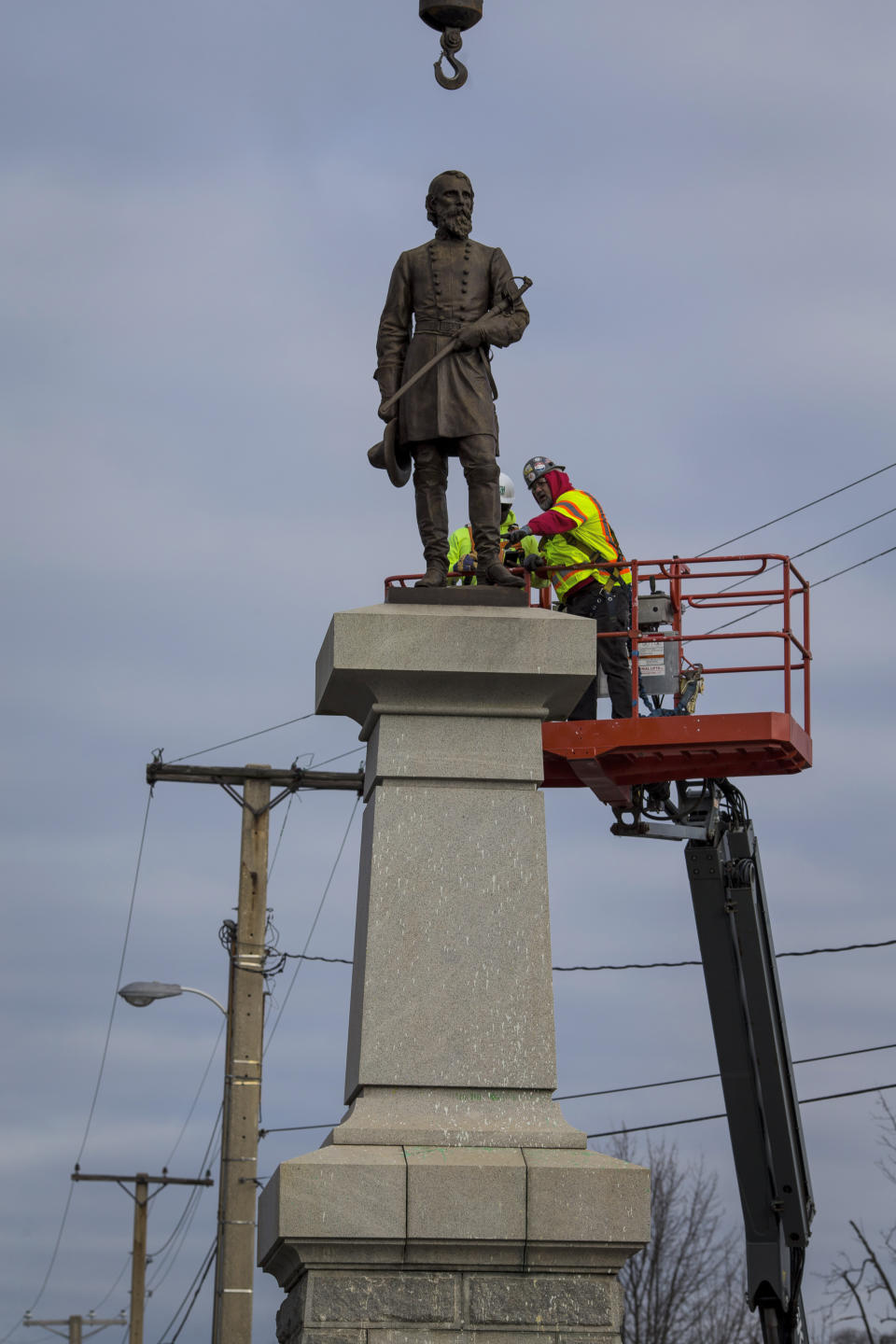 Workers remove the bronze statue of Confederate Lieutenant General A.P. Hill on Monday Dec. 12, 2022 in Richmond, Va. (AP Photo/John C. Clark)