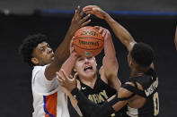 Army's Charlie Peterson reaches for a rebound between Florida's Omar Payne, left, and Army's Josh Caldwell, right, in the second half of an NCAA college basketball game, Wednesday, Dec. 2, 2020, in Uncasville, Conn. (AP Photo/Jessica Hill)