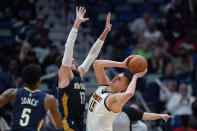 New Orleans Pelicans center Jonas Valanciunas (17) defends against Denver Nuggets center Nikola Jokic (15) in the second half of an NBA basketball game in New Orleans, Wednesday, Dec. 8, 2021. The Nuggets won in overtime 120-114. (AP Photo/Gerald Herbert)