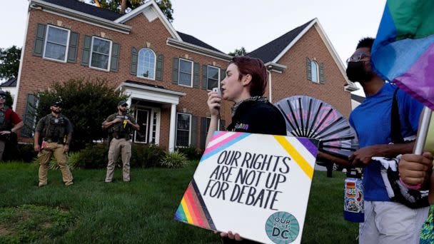 PHOTO: US Marshals watch abortion rights activists march outside the home of conservative Supreme Court Justice Amy Coney Barrett, in Falls Church, Va., June 30, 2022. (Michael Reynolds/EPA via Shutterstock)