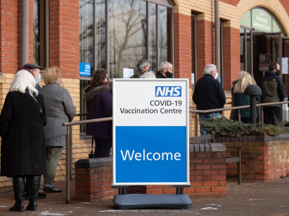 <p>People queue outside an NHS mass vaccination centre in Stevenage, one of several opening this week, to receive a Covid-19 jab</p> (Getty)