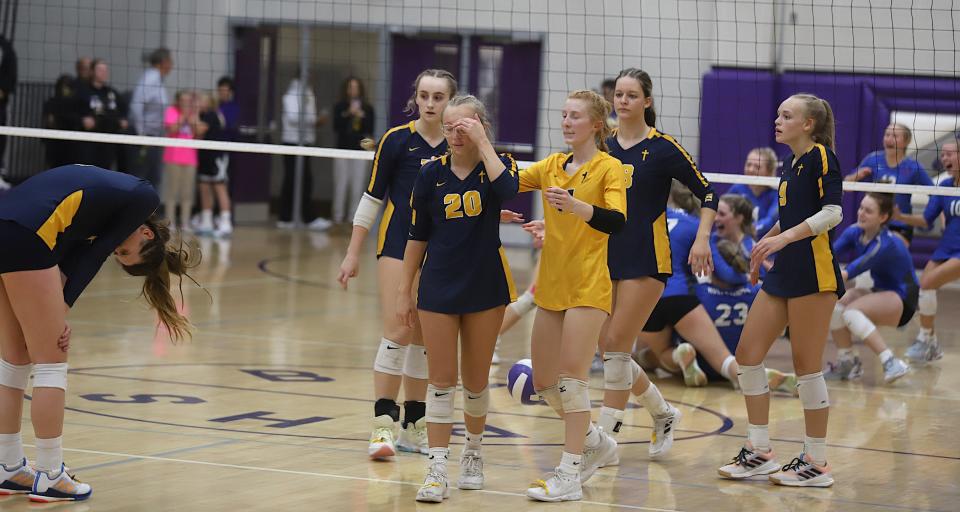 Notre Dame’s Gabby Deery (11), left, and other players are dejected after a 3-1 loss against Holy Trinity in a Class 1A regional final Wednesday in Burlington.