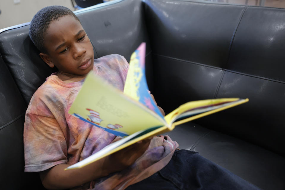 Michael Crowder, 11, reads during a daily after-school literacy program in Atlanta on Thursday, April 6, 2023. Of the students who are still behind, his elementary school teacher, La’Neeka Gilbert-Jackson is the least worried about one: Michael. She's confident he'll find a way to navigate the new world ahead of him — a world where he'll have to be more self-sufficient, even if there is too much to learn. “He wants it,” she says. “He'll catch up.” (AP Photo/Alex Slitz)