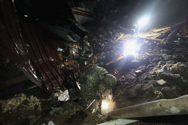 First responders examine the rubble after the Russian missile strike on central Kharkiv, northeastern Ukraine. -/Ukrinform/dpa