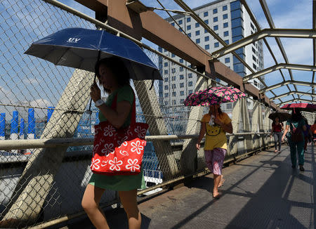 Commuters pass through an elevated pedestrian walkway on Commonwealth Avenue in Quezon City, metro Manila, May 23, 2018. REUTERS/Dondi Tawatao