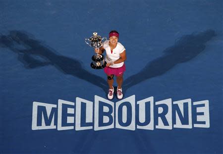 Li Na of China poses with The Daphne Akhurst Memorial Cup after defeating Dominika Cibulkova of Slovakia in their women's singles final match at the Australian Open 2014 tennis tournament in Melbourne January 25, 2014. REUTERS/David Gray