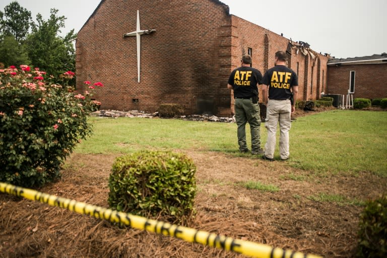 Investigators with the Bureau of Alcohol, Tobacco and Firearms examine the burned ruins of the Mt. Zion AME Church in Greeleyville, South Carolina, on July 1, 2015