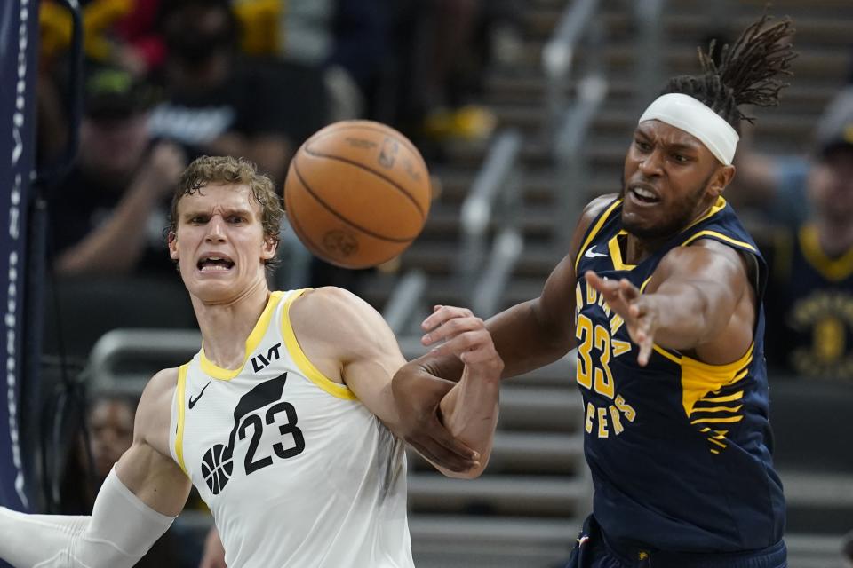 Indiana Pacers' Myles Turner (33) and Utah Jazz's Lauri Markkanen (23) battle for a loose ball during the second half of an NBA basketball game, Wednesday, Nov. 8, 2023, in Indianapolis. (AP Photo/Darron Cummings)