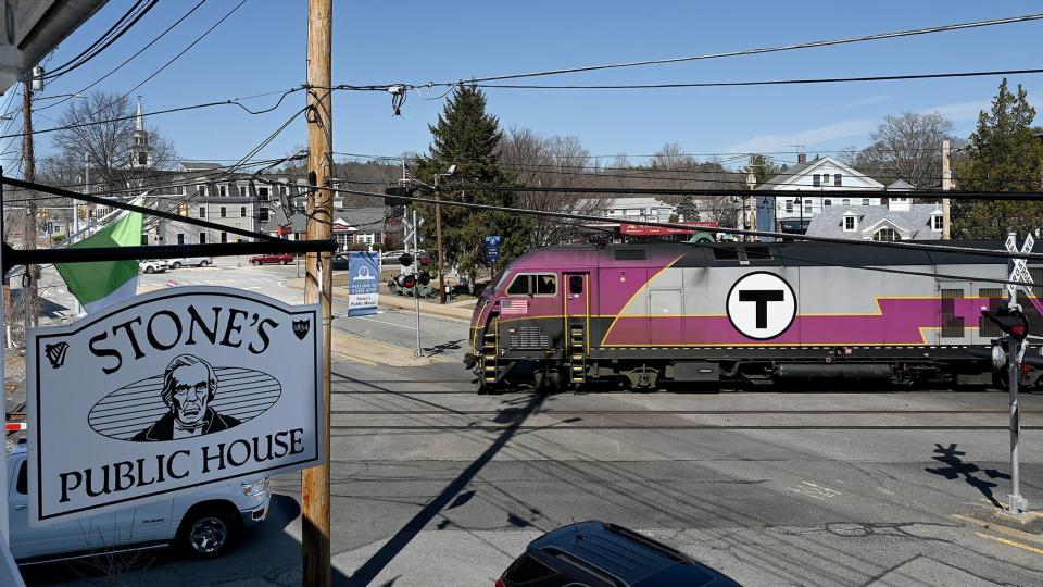 A train moves through the Main Street crossing in Ashland in this 2021 file photo. Police say a commuter train struck an automobile that became stuck at the crossing late Sunday afternoon.